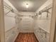 Organized walk-in closet with shelving and hanging space for efficient storage solutions at 57 Sandstone Cir, Venice, FL 34293