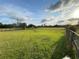 Expansive backyard featuring luscious green lawn and mature trees at 5760 Howard Creek Rd, Sarasota, FL 34241