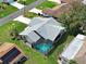 Aerial view of a beautiful home featuring a screened-in pool, surrounded by lush landscaping at 5832 Monroe Rd, Venice, FL 34293