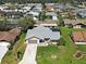 Aerial view of home highlighting the roof, driveway and landscaped front yard in a quiet neighborhood at 5832 Monroe Rd, Venice, FL 34293