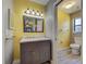 Bathroom with grey vanity, light fixtures, and a view to the toilet and shower at 5832 Monroe Rd, Venice, FL 34293