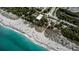 Aerial view showcasing the sandy beach, turquoise waters, and coastal landscape at 5832 Monroe Rd, Venice, FL 34293