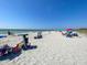 Sandy beach view with people enjoying sunny day under blue skies at 5832 Monroe Rd, Venice, FL 34293