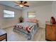 Bedroom with hardwood floors, two windows and a ceiling fan at 5832 Monroe Rd, Venice, FL 34293