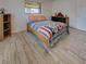 Bedroom with wood floor, window and patriotic decor at 5832 Monroe Rd, Venice, FL 34293