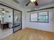 Bright room with hardwood floors, sliding glass doors, and views into another bedroom at 5832 Monroe Rd, Venice, FL 34293