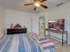 Bedroom featuring hardwood floors, ceiling fan, and a view of the kitchen at 5832 Monroe Rd, Venice, FL 34293