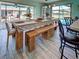 Dining room with wooden table set and seating for six, next to the outdoor pool at 5832 Monroe Rd, Venice, FL 34293