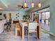 This bright dining room features a wood table, decorative light fixtures, and an open layout at 5832 Monroe Rd, Venice, FL 34293