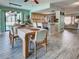 Dining room with an open floorplan and tile flooring with access to the kitchen and outdoor pool area at 5832 Monroe Rd, Venice, FL 34293