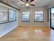 Bright room with hardwood floors, windows, a ceiling fan, and a sliding glass door at 5832 Monroe Rd, Venice, FL 34293