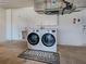 Clean laundry area with washer and dryer, featuring storage cabinets and convenient utility sink at 5832 Monroe Rd, Venice, FL 34293