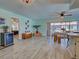 Bright living room with tile floors, a dining area, and easy access to the outdoor patio at 5832 Monroe Rd, Venice, FL 34293