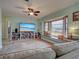 Open-concept living room features a large window, cozy seating, a TV, and built-in shelving at 5832 Monroe Rd, Venice, FL 34293