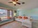 Comfortable living room features a large window, ceiling fan, and a cozy sectional sofa at 5832 Monroe Rd, Venice, FL 34293