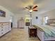 Spacious main bedroom with wood floors, dresser, bed and ensuite bathroom at 5832 Monroe Rd, Venice, FL 34293