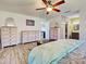 Spacious primary bedroom featuring wood-look floors, a dresser, and a ensuite bathroom at 5832 Monroe Rd, Venice, FL 34293