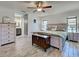 The primary bedroom features wood-look floors, shiplap accents, an ensuite bathroom, and lots of natural light at 5832 Monroe Rd, Venice, FL 34293