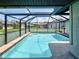 Refreshing screened-in pool, with clear blue water, offers a private retreat for relaxation and outdoor enjoyment at 5832 Monroe Rd, Venice, FL 34293