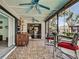Charming screened-in patio with a ceiling fan, tile floors, offering views of the outdoors at 5832 Monroe Rd, Venice, FL 34293