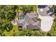 A bird's-eye view of a luxurious home featuring a pool, fire pit area, and meticulously designed landscaping at 5850 Saddle Oak Trl, Sarasota, FL 34241