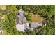 An aerial view showcasing a sprawling property with a house, pool, garage, and lush landscaping at 5850 Saddle Oak Trl, Sarasota, FL 34241