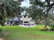 Expansive backyard with a stone patio, fire pit, and partial view of the home at 5850 Saddle Oak Trl, Sarasota, FL 34241