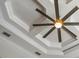 Close up of a ceiling fan with decorative ceiling and recessed lighting at 5850 Saddle Oak Trl, Sarasota, FL 34241