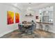 Stylish dining area with modern lighting, unique art, and seamless flow into the open kitchen at 5850 Saddle Oak Trl, Sarasota, FL 34241