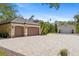 Extensive paver driveway leads to a three-car garage and a large detached garage, perfect for car enthusiasts or extra storage at 5850 Saddle Oak Trl, Sarasota, FL 34241