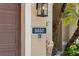 Address plaque is mounted beside the front door on a stucco wall with manicured foliage at 5850 Saddle Oak Trl, Sarasota, FL 34241