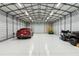 A well-lit garage showcasing ample space, a car, and recreational vehicles at 5850 Saddle Oak Trl, Sarasota, FL 34241