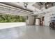 Spacious three car garage with epoxy floors and garage door openers at 5850 Saddle Oak Trl, Sarasota, FL 34241