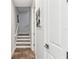 Hallway leading to the stairs boasts unique tile flooring and access to different levels of the home at 5850 Saddle Oak Trl, Sarasota, FL 34241