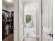 Hallway view leading to a luxurious bathroom with a soaking tub and chandelier at 5850 Saddle Oak Trl, Sarasota, FL 34241