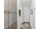 Bright hallway features glossy storage cabinets and unique tile flooring leading to the home's entrance at 5850 Saddle Oak Trl, Sarasota, FL 34241