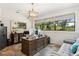 Well-lit home office features an executive desk, large windows, and elegant decor for a productive workspace at 5850 Saddle Oak Trl, Sarasota, FL 34241