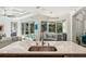 Open kitchen with an island, view of the pool area, and stylish lighting at 5850 Saddle Oak Trl, Sarasota, FL 34241