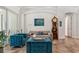Cozy living room with elegant furnishings, a decorative clock, and access to outdoor living spaces at 5850 Saddle Oak Trl, Sarasota, FL 34241