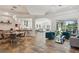 Open-concept living area features a dining area, comfortable seating, and views of the kitchen and outdoor spaces at 5850 Saddle Oak Trl, Sarasota, FL 34241