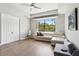 Bright living room features a ceiling fan, hardwood floors, and a large window with natural light at 5850 Saddle Oak Trl, Sarasota, FL 34241