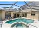 Screened-in pool with hot tub and patio seating at 5850 Saddle Oak Trl, Sarasota, FL 34241