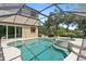Screened-in pool with hot tub and sliding glass doors at 5850 Saddle Oak Trl, Sarasota, FL 34241