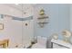 Modern bathroom with a glass-enclosed shower, decorated with gold fixtures and chic shelving for a spa-like experience at 5872 Monroe Rd, Venice, FL 34293