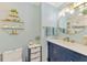 Stylish bathroom featuring a modern vanity, elegant mirror, and decorative shelving, offering a blend of functionality and design at 5872 Monroe Rd, Venice, FL 34293