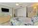 Comfortable bedroom features light green walls, a ceiling fan and stylish woven furniture, creating a cozy retreat at 5872 Monroe Rd, Venice, FL 34293