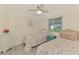 Comfortable bedroom with twin beds, ceiling fan, window bringing in natural light, and relaxing decor at 5872 Monroe Rd, Venice, FL 34293