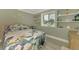 Bright bedroom with natural light, decorated with elegant floral bedding and ample storage with built-in shelves at 5872 Monroe Rd, Venice, FL 34293