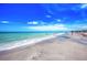 Picturesque coastal view of a sandy beach, swimmers in the ocean, and a clear blue sky at 5872 Monroe Rd, Venice, FL 34293