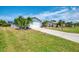 Well-maintained single-story home featuring mature landscaping, a spacious two-car garage and concrete driveway at 5872 Monroe Rd, Venice, FL 34293